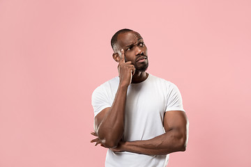 Image showing Young serious thoughtful businessman. Doubt concept.