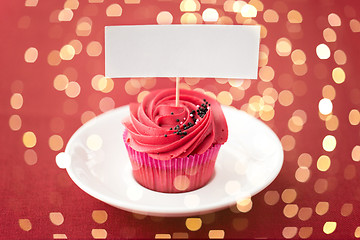 Image showing close up of cupcake with red buttercream frosting