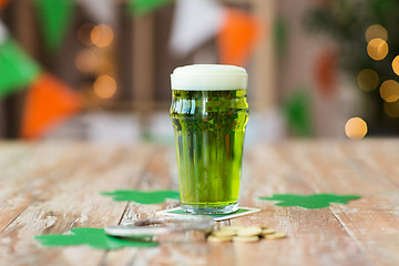 Image showing glass of green beer, horseshoe and golden coins