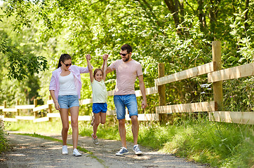 Image showing happy family walking in summer park