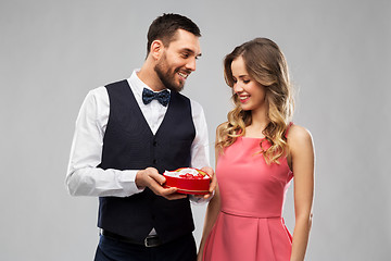 Image showing happy couple with chocolate box in shape of heart