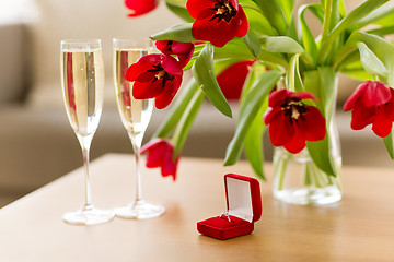 Image showing diamond ring, champagne and flowers on table