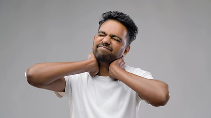 Image showing tired indian man suffering from neck pain