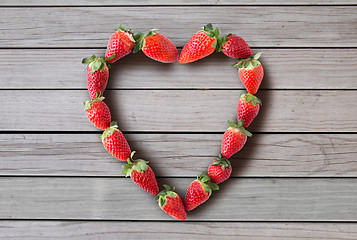 Image showing heart shaped frame made of strawberries