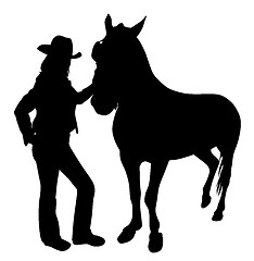 Image showing Cowgirl standing with horse