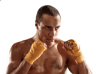 Image showing Sporty man during boxing exercise. Photo of boxer on white background