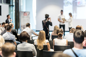 Image showing Young business team receiving award at best business project competition event.