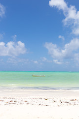 Image showing Fishing boat on picture perfect white sandy beach with turquoise blue sea, Paje, Zanzibar, Tanzania.