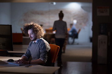 Image showing man working on computer in dark office