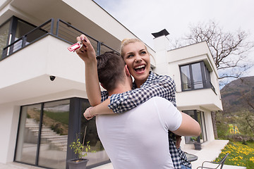 Image showing couple hugging in front of  new luxury home