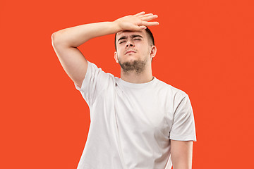 Image showing Man having headache. Isolated over orang background.