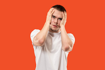 Image showing Man having headache. Isolated over orang background.