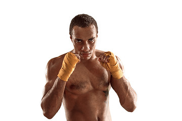 Image showing Sporty man during boxing exercise. Photo of boxer on white background