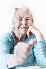 Image showing Happy 96 years old elderly woman giving a thumb up and looking at camera.