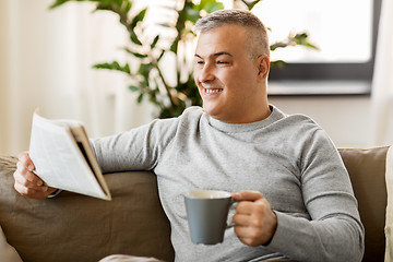 Image showing man reading newspaper and drinking coffee at home