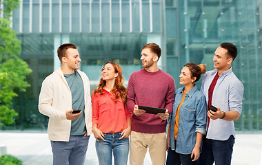 Image showing students with gadgets over university background