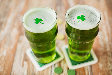 Image showing glasses of green beer with shamrock and gold coins