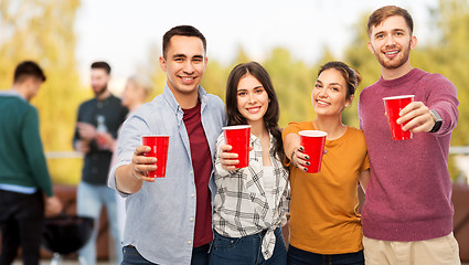 Image showing group of friends toasting drinks at rooftop party