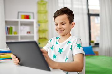 Image showing student boy with tablet pc and notebook at home