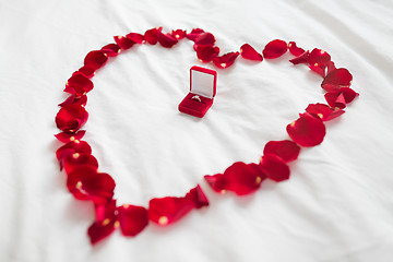 Image showing heart made of petals and diamond ring in gift box