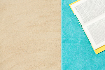 Image showing book on beach towel on sand