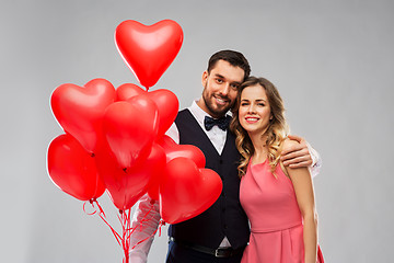 Image showing happy couple with red heart shaped balloons