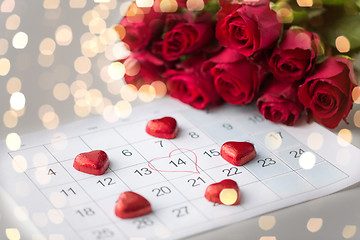 Image showing close up of calendar, heart, candies and red roses