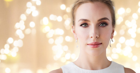 Image showing woman in white dress with diamond earring