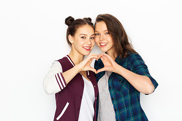 Image showing happy smiling teenage girls showing heart sing