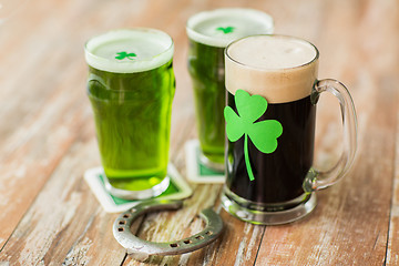 Image showing shamrock on glass of beer and horseshoe on table