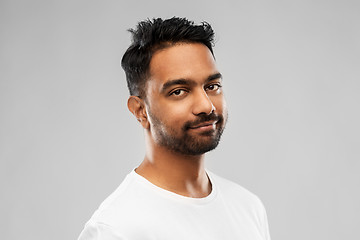 Image showing smiling young indian man over gray background