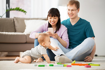 Image showing mixed race family with baby son playing at home