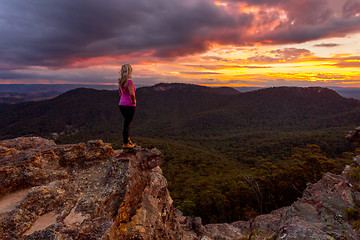 Image showing Woman watching storm clouds over Blue Mountains at sunset