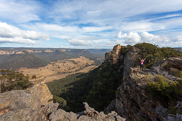 Image showing Adventurous hiker explorer reaching the top slab of Donkey Mount