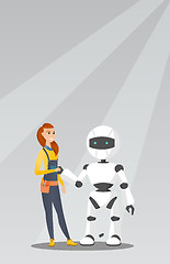 Image showing Young caucasian woman handshaking with robot.