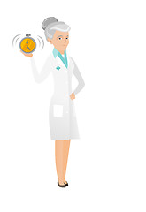 Image showing Senior caucasian doctor holding alarm clock.