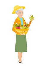 Image showing Farmer harvesting harvest of vegetables and fruits