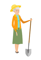 Image showing Senior caucasian farmer holding a shovel.