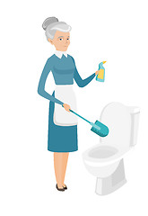 Image showing Senior caucasian cleaner cleaning toilet bowl.