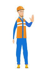 Image showing Young caucasian builder showing stop hand gesture