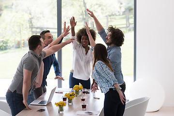 Image showing multiethnic startup Group of young business people celebrating s