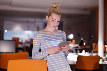 Image showing woman working on digital tablet in night office