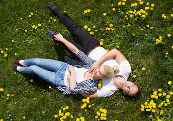 Image showing man and woman lying on the grass