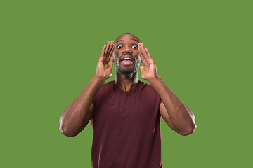 Image showing young casual man shouting at studio