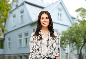 Image showing teenage girl in checkered shirt over house