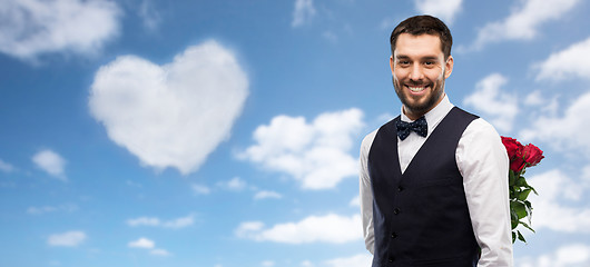 Image showing happy man with red roses behind his back