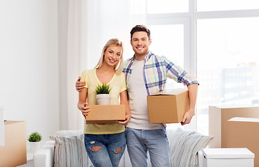 Image showing happy couple with boxes moving to new home