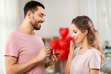 Image showing man giving woman engagement ring on valentines day