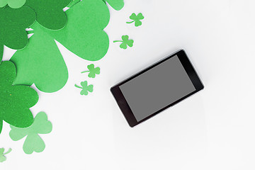 Image showing tablet pc and st patricks day decorations on white