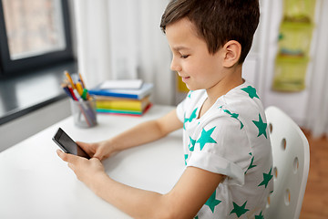 Image showing happy boy with smartphone at home